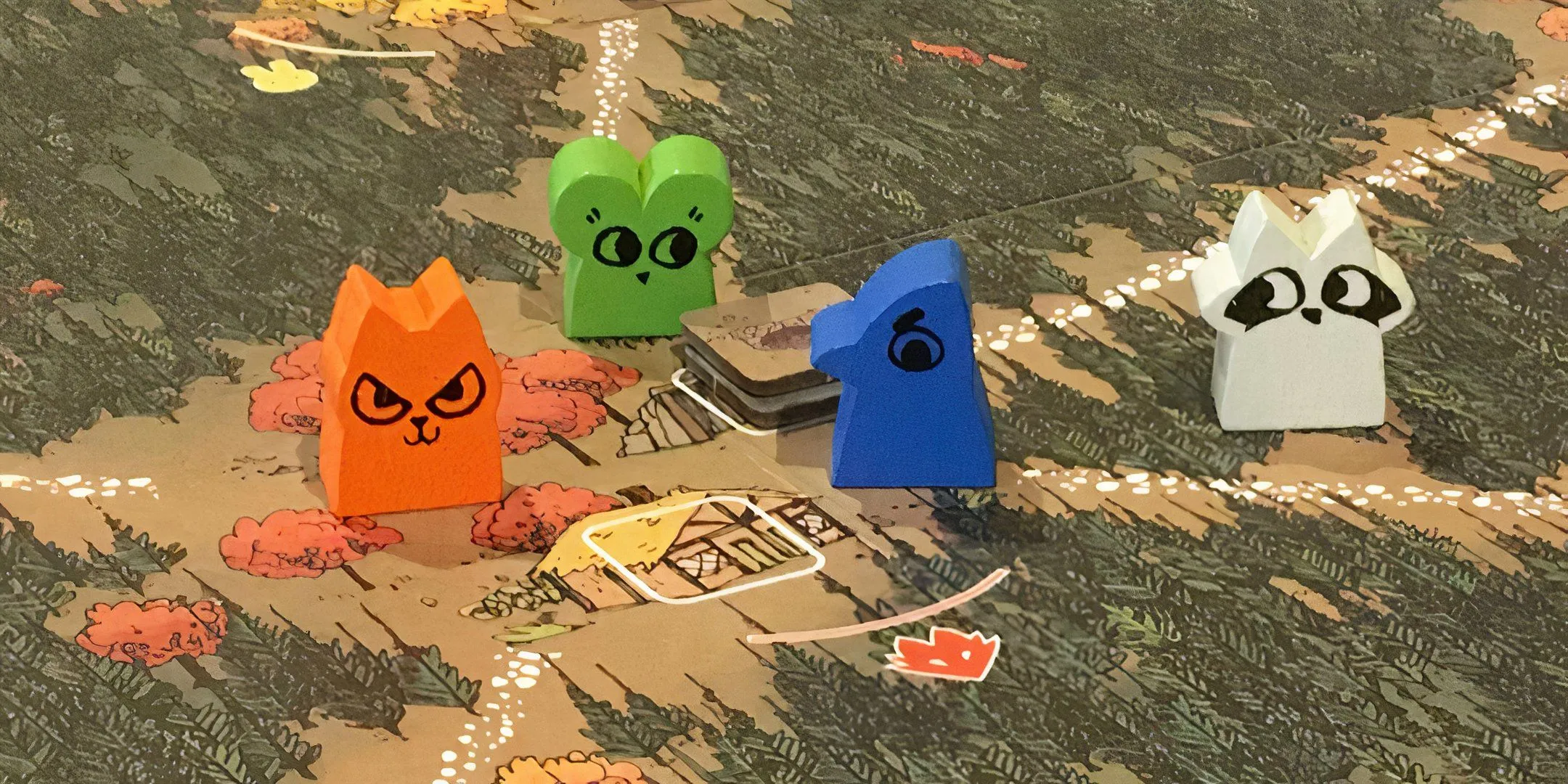 Bốn quân cờ gỗ hình động vật dễ thương trên bản đồ game Root, thể hiện cuộc chiến tranh giành lãnh thổ giữa các phe phái.